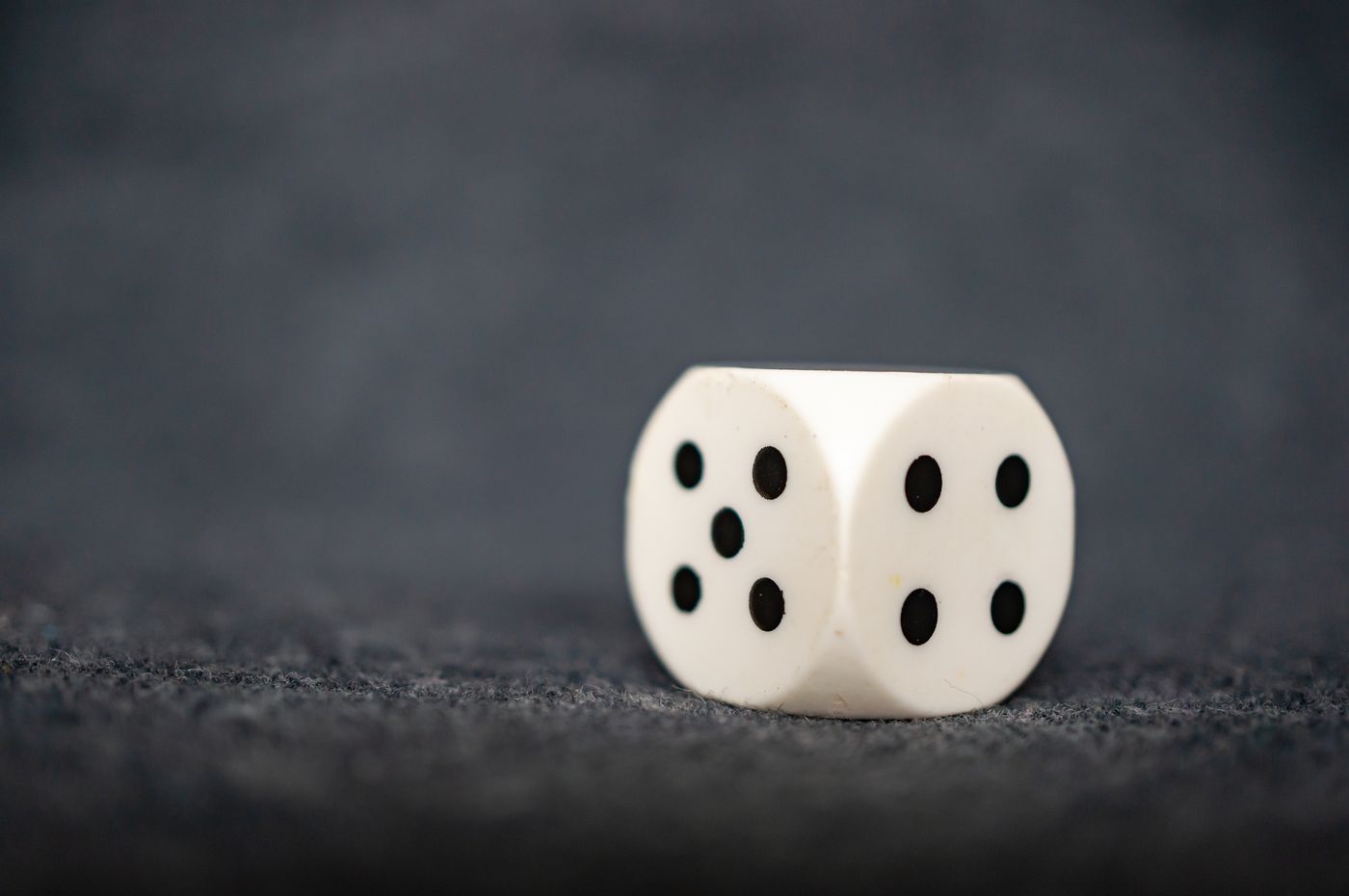 A single white die, a reminder to evaluate a forecast by the odds it states