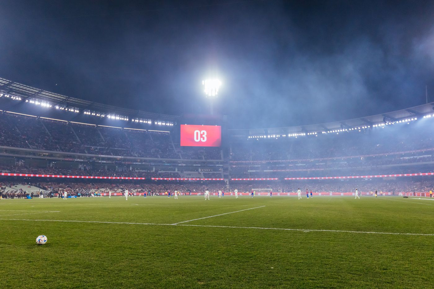 A floodlit soccer stadium at night, illustrating the World Cup espionage case involving Qatar