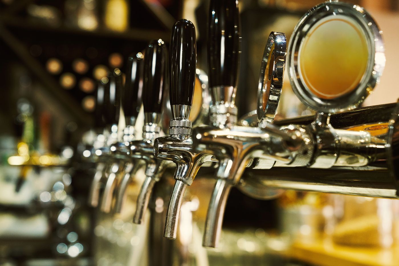 A row of beer taps, the subject of a twenty-year trend analysis of the beer industry