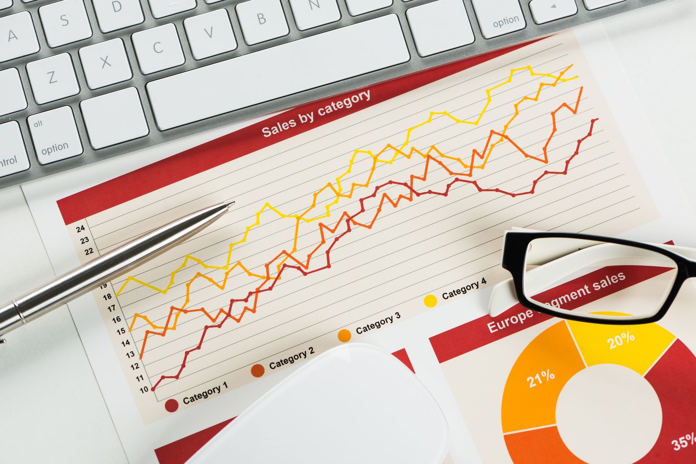 Printed line charts on a desk, the raw material of trend analysis